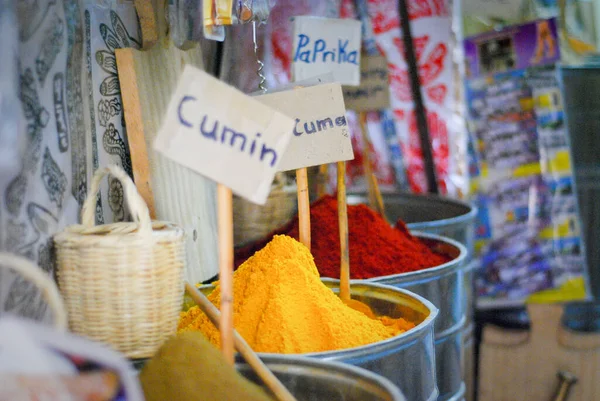 Barrels of spices in Marrakech market in Morocco with labels of cumin and paprika. High quality photo. Colorful saturated spices.