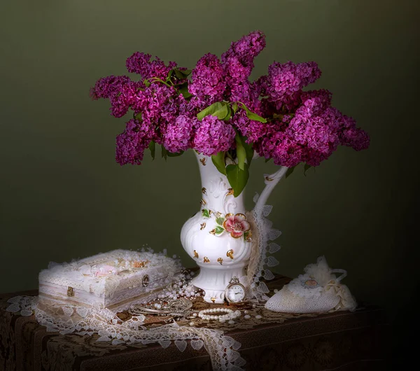 bouquet of burgundy lilacs in a vase on the table