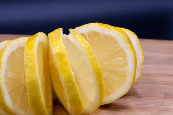 lemon cut on cutting board with black background