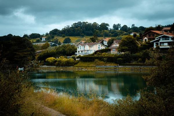 home near the lake with garden surrounded by trees with pier and boat. summer house in search of tranquility.