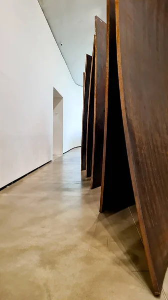 Rusty metal sculpture in museum with high lights