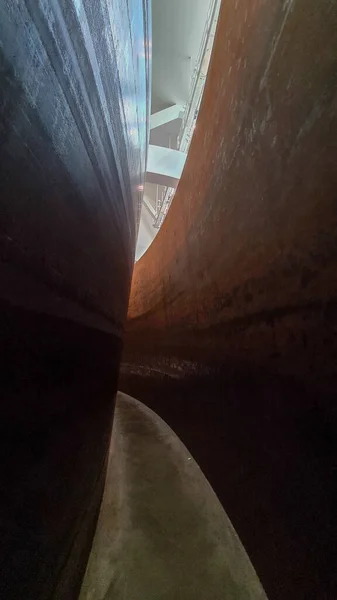 Rusty metal sculpture in museum with high lights