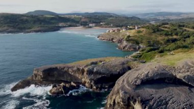 aerial view with drone of the cantabrian coast with the sea entering and the village in the background with the beach on a sunny day.