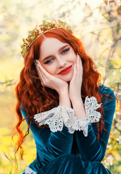 Close-up portrait happy red-haired woman queen in golden crown on head looking at camera. Girl joyful cheerful princess smiling face, green renaissance victorian dress. Red lips pale skin long hair — Stockfoto