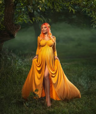 fantasy photo pregnant woman queen hugs belly. Pregnancy long outfit creative design ancient vintage greek style elegant yellow dress. Gold wreath crown on head. Goddess of fertility. summer nature.