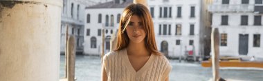  charming woman smiling at camera on blurred background in Venice, banner clipart