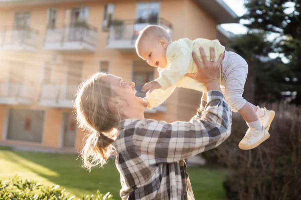 Cheerful father playing with baby girl on urban street in Treviso — Stock Photo