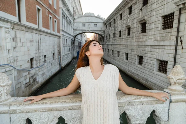 Junge Frau mit geschlossenen Augen in der Nähe der Seufzerbrücke und des mittelalterlichen Gefängnisses in Venedig — Stockfoto