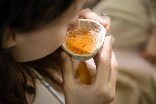 High angle view of blurred woman drinking tea in bowl in forest — Stock Photo