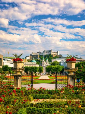 Beautiful view of famous Mirabell Gardens with the old historic Fortress Hohensalzburg in the background in Salzburg, Austria. Famous Mirabell Gardens with historic Fortress in Salzburg, Austria.