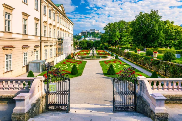 Beautiful view of famous Mirabell Gardens with the old historic Fortress Hohensalzburg in the background in Salzburg, Austria. Famous Mirabell Gardens with historic Fortress in Salzburg, Austria.