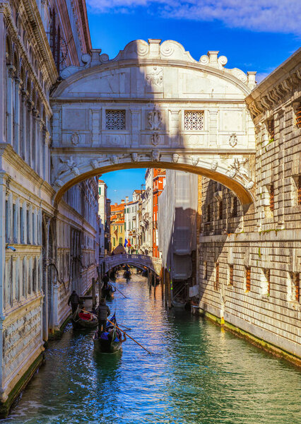 View of the famous Bridge of Sighs in Venice, Italy. Traditional Gondola and the famous Bridge of Sighs in Venice, Italy. Gondolas floating on canal towards Bridge of Sighs (Ponte dei Sospiri). Venice, Italy