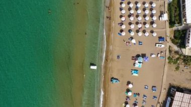 Yunanistan 'ın Korfu adasındaki Agios Gordios egzotik plajı. Agios Gordios plajı, Korfu adası, Yunanistan. Agios Gordios plajının panoramik manzarası, kumlu deniz kıyıları, plaj şemsiyeleri ve şezlonglar..