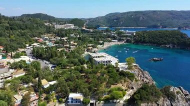 Picturesque seaside of Paleokastritsa, Corfu, Greece. Beautiful bay in Paleokastritsa in Corfu island, Greece. Panoramic view of Palaiokastritsa, boats and beach Corfu, Greece