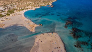Aerial view of beautiful tropical Elafonissi Beach with pink sand. View of a nice tropical Elafonissi beach from the air. Beautiful sky, sea, resort. Elafonissi beach, Crete, Greece.