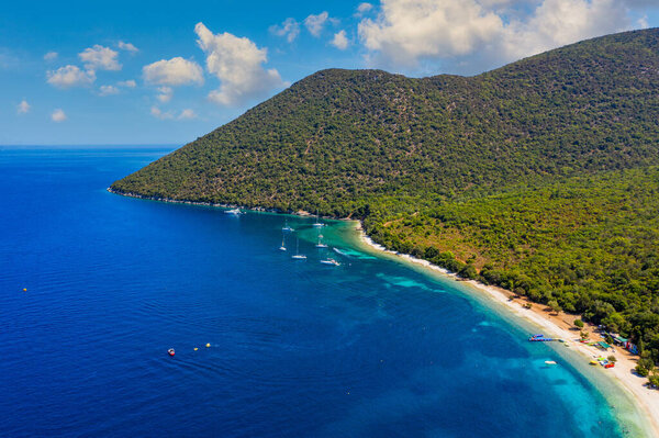 Чистая лазурная вода на пляже Антисамос на греческом острове Кефалония. Морской залив с пляжем Антисамос на острове Кефалония, Ионический остров, Цефалония, пляж Антисамос, Греция. 