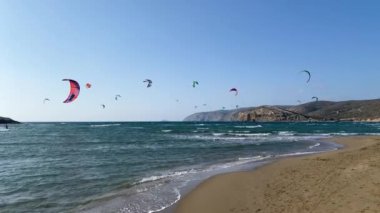 Surfers in Prasonisi Beach in Rhodes island, Greece. Kiteboarder kitesurfer athlete performing kitesurfing kiteboarding tricks. Prasonisi Beach is popular location for surfing. Greece