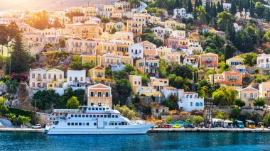 View of the beautiful greek island of Symi (Simi) with colourful houses and small boats. Greece, Symi island, view of the town of Symi (near Rhodes), Dodecanese.