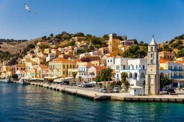 View of the beautiful greek island of Symi (Simi) with colourful houses and small boats. Greece, Symi island, view of the town of Symi (near Rhodes), Dodecanese.