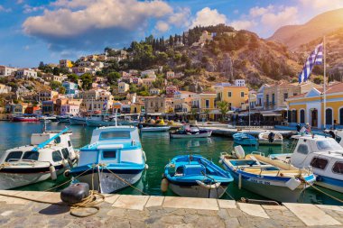 View of the beautiful greek island of Symi (Simi) with colourful houses and small boats. Greece, Symi island, view of the town of Symi (near Rhodes), Dodecanese.