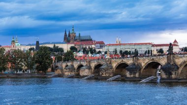 Prague Castle, Charles Bridge and boats on the Vltava river. View of Hradcany Prague Castle, Charles Bridge and a boats on the Vltava river in the capital of the Czechia. 