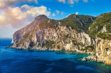 Picturesque seaside of Paleokastritsa, Corfu, Greece. Beautiful bay in Paleokastritsa in Corfu island, Greece. Panoramic view of Palaiokastritsa, boats and beach Corfu, Greece