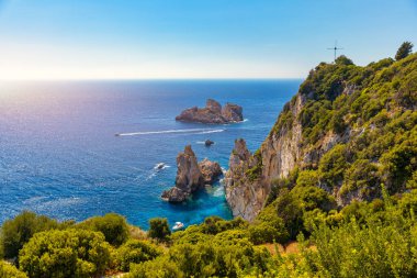 Picturesque seaside of Paleokastritsa, Corfu, Greece. Beautiful bay in Paleokastritsa in Corfu island, Greece. Panoramic view of Palaiokastritsa, boats and beach Corfu, Greece