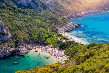 Porto Timoni is an amazing beautiful double beach in Corfu, Greece. Porto Timoni beach at Afionas is a paradise double beach with crystal clear azure water in Corfu, Ionian island, Greece, Europe