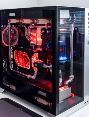 Prague, Czech Republic - 21 July 2021: Close-up of high performance Desktop PC and water cooling system with multicolored LED RGB light show status on working, interior on Computer PC Case and DIY