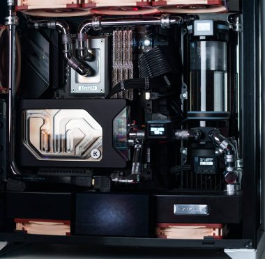 Prague, Czech Republic - 21 July 2021: Close-up of high performance Desktop PC and water cooling system with multicolored LED RGB light show status on working, interior on Computer PC Case and DIY