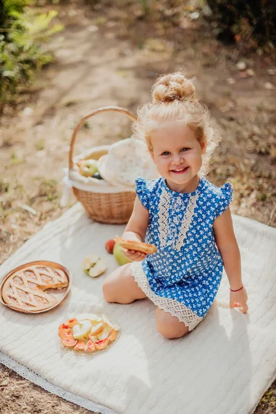 Little girl with a pie in the park