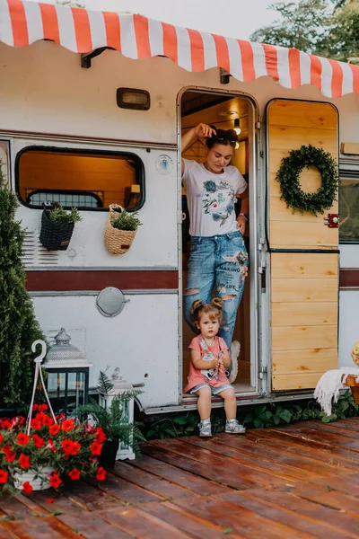 Little girl wih her mother play in a camping in summer