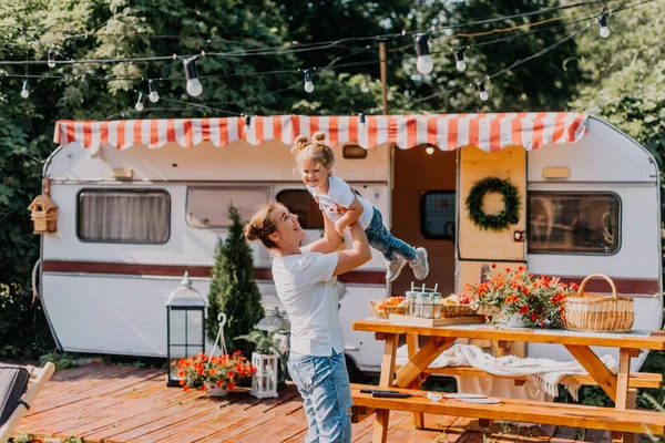 Little girl wih her mother play in a camping in summer