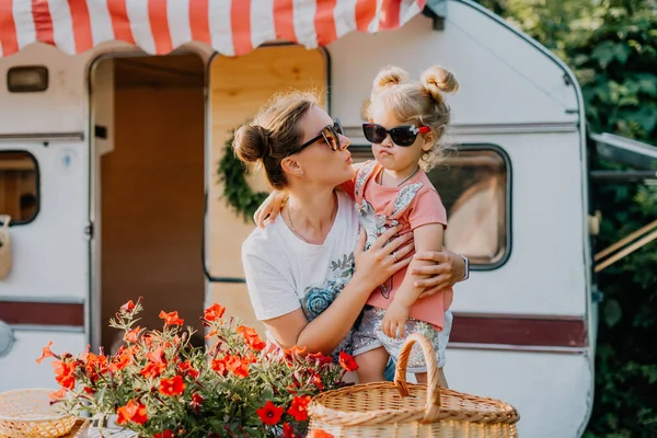 Little girl wih her mother play in a camping in summer