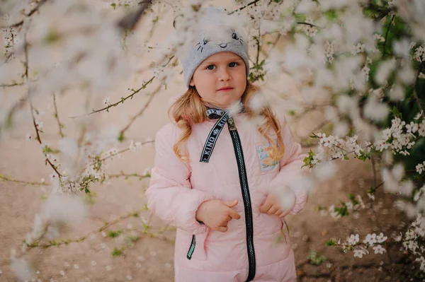 Girl in white blooming trees