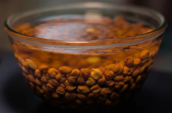 Bengal Gram or Black Gram or Chickpeas soaked in glass bowl water