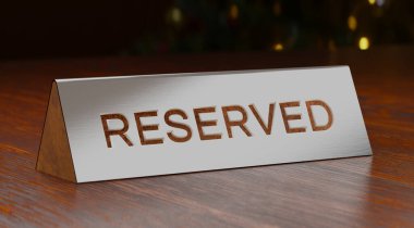 Glossy metal Reserved Table sign or tag on wooden surface, 3D render.