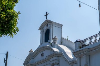 Katolik kilisesinin giriş kapısının üst kısmının dış görünüşü ve kutsal haç.