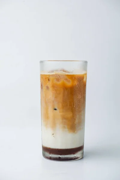 在白色背景上隔离的杯子上垂直拍摄的新鲜冰镇牛奶咖啡 — 图库照片