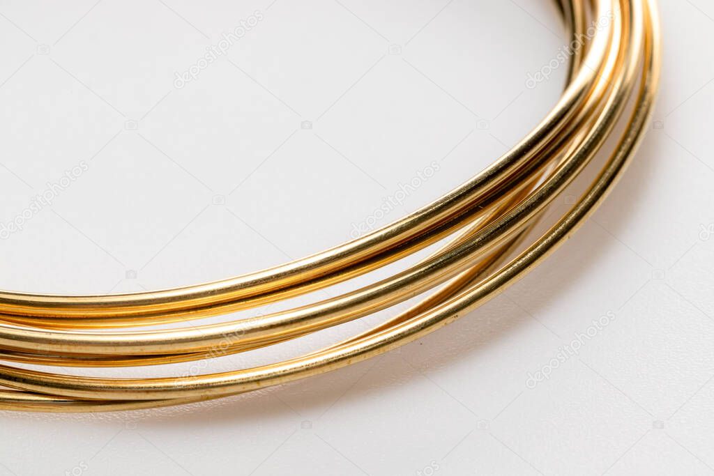 Gold wire for jewelry making isolated on white background