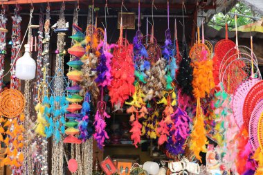 Göz kamaştırıcı renkli ıvır zıvırlar. Hindistan 'da, Pondicherry' de bir zanaat pazarında düş kapanları ve çeşitli el sanatları..