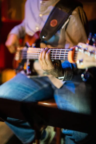 ニューヨークのロックウッド ミュージック ホールでのジャズ パフォーマンスで演奏するギタリストの手の垂直ショット — ストック写真