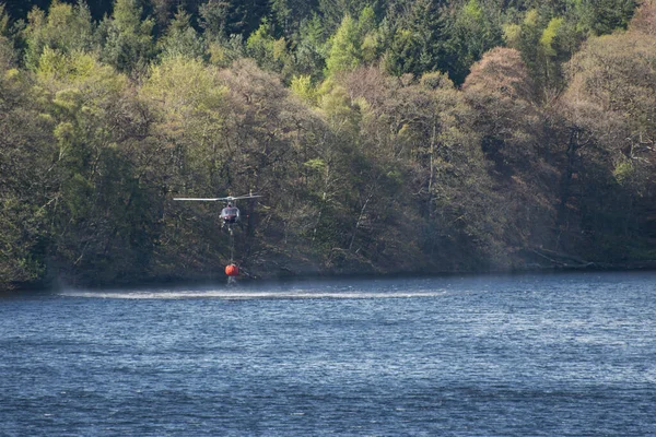 湖から水を集め 森林火災を消火するヘリコプター — ストック写真
