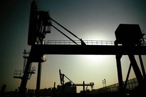 The silhouettes of the industrial buildings at sunset. Shanghai, China.