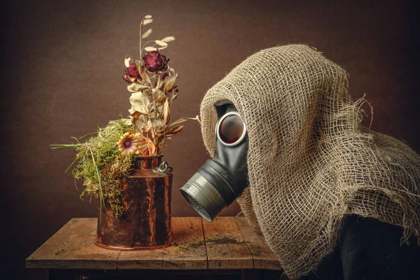 Person Gas Mask Sitting Next Wooden Table Dry Flower Vase — Stock Photo, Image