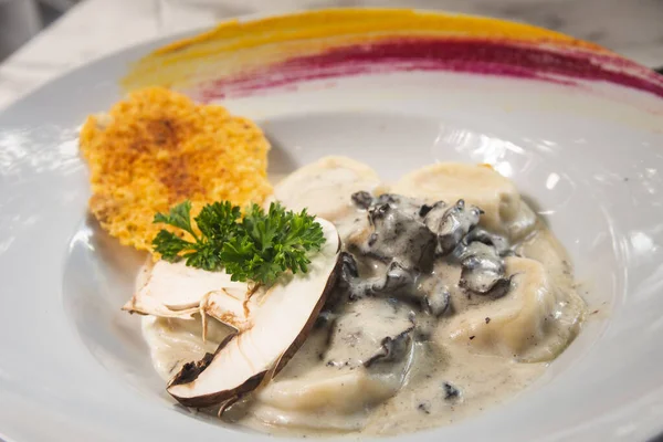 Kasede mantar sosuyla kaplanmış Tortellini 'nin yakın çekimi.