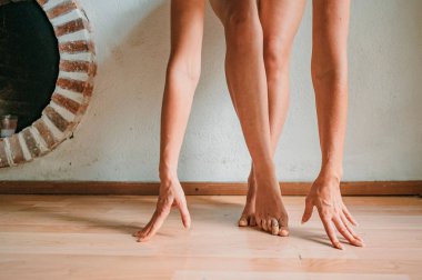 Dans eden, çıplak ayaklı, odada bikini giyen bir kadın..