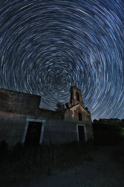 在时光流逝的星空背景下垂直拍摄的旧教堂立面 — 图库照片