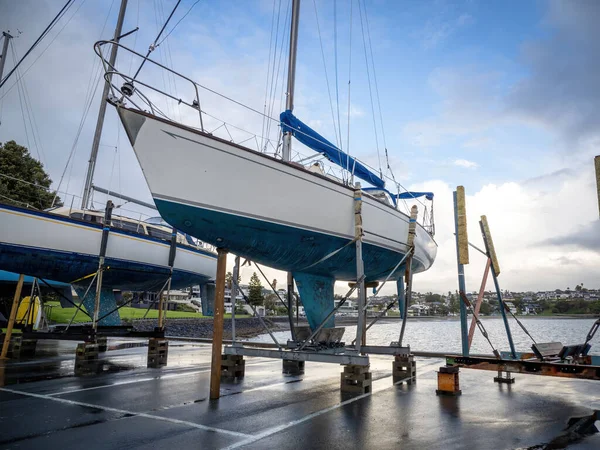 View of Small yacht on dry dock stand being repaired