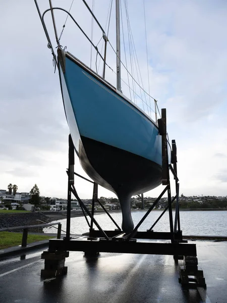 View of Small yacht on dry dock stand being repaired